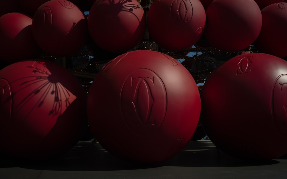 a bunch of red balls sitting next to each other