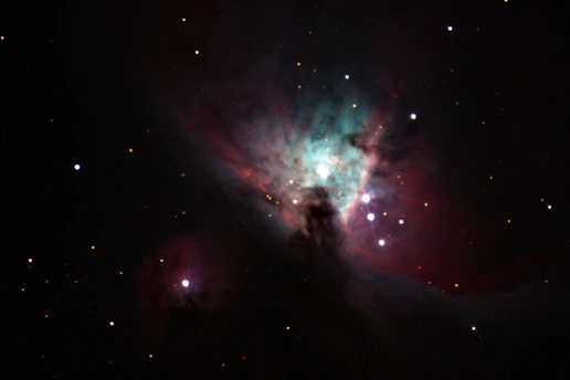 A vibrant cosmic nebula glowing with colorful gases and distant stars.