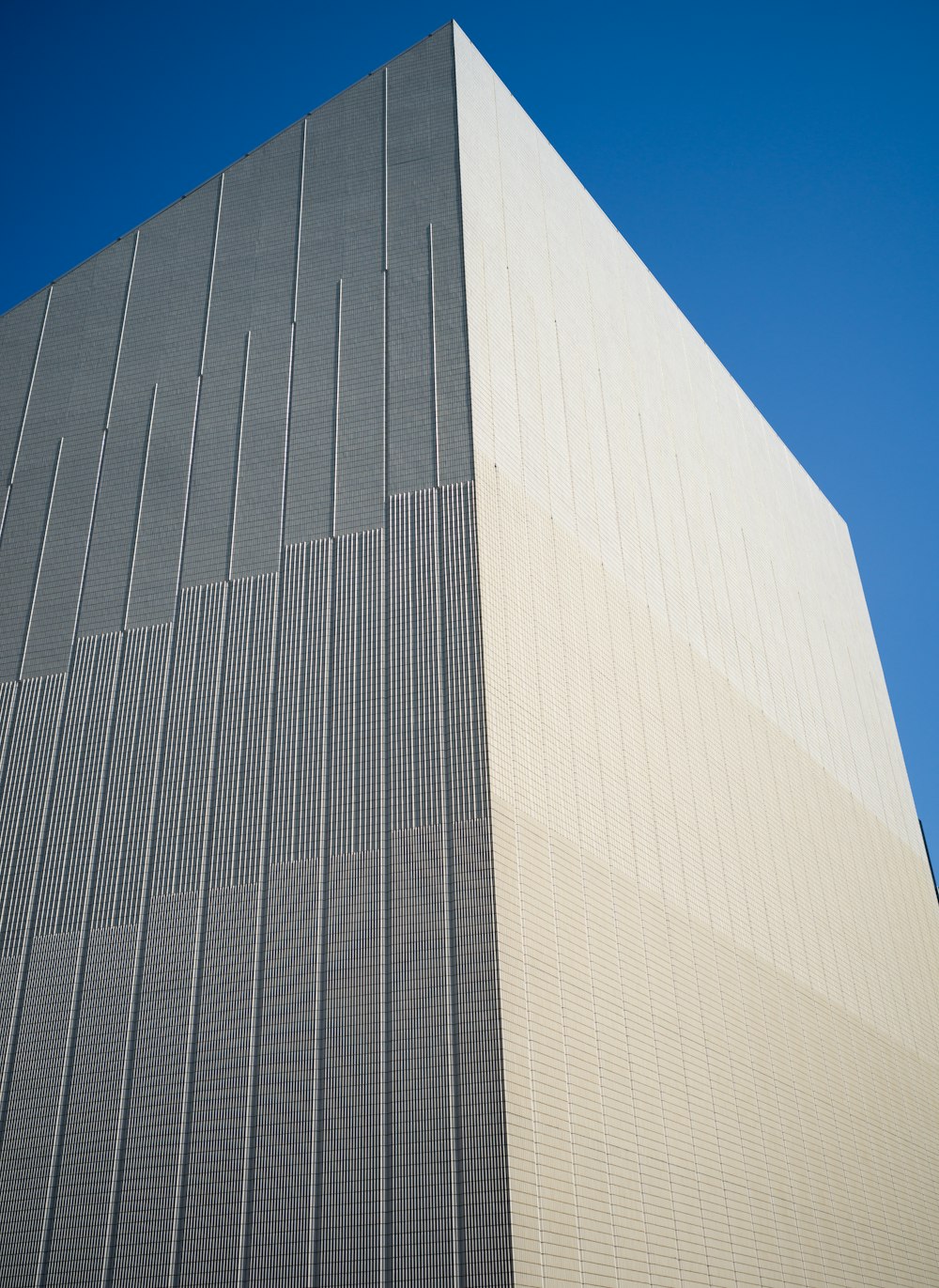 a tall building with a blue sky in the background