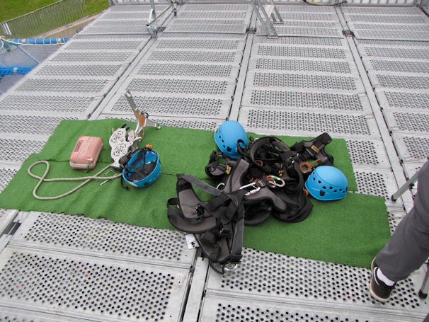 Detailed view of safety equipment and ropes arranged neatly before a job.