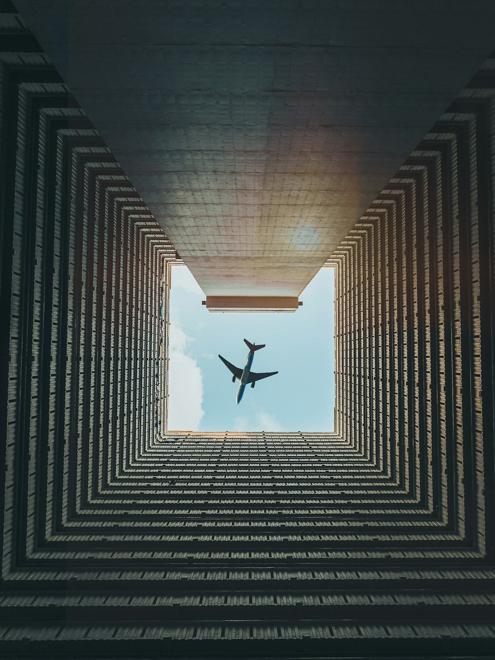 an airplane is flying through a tunnel of bricks
