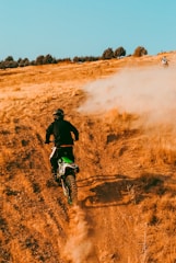 a person riding a dirt bike on a dirt road