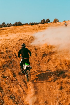 a person riding a dirt bike on a dirt road
