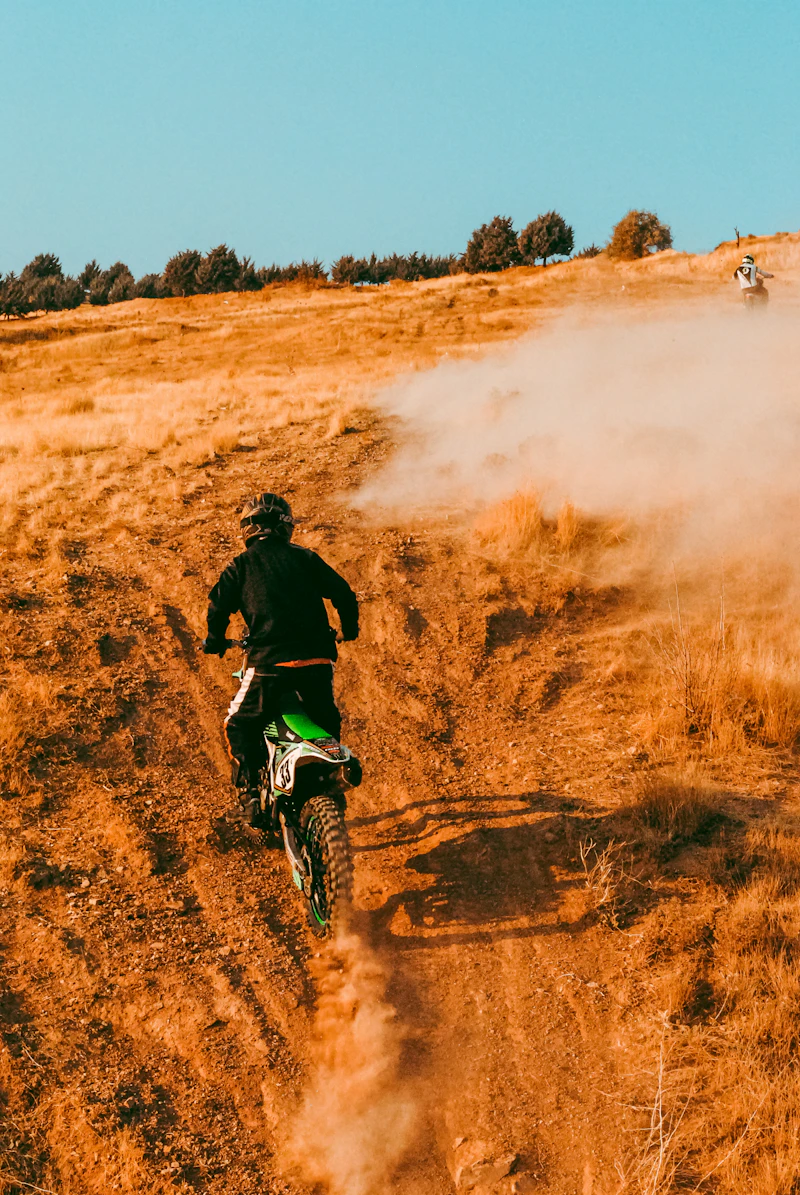 Rider on an adventure motorbike on an open dirt road — Ride For Light charity rides