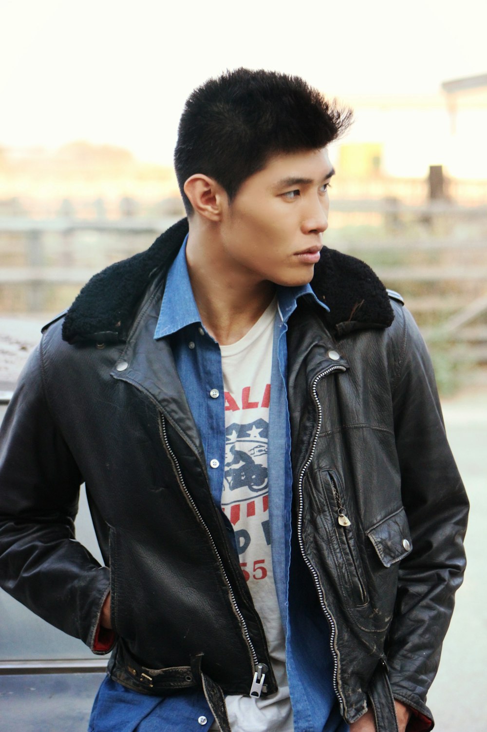 a young man in a black leather jacket