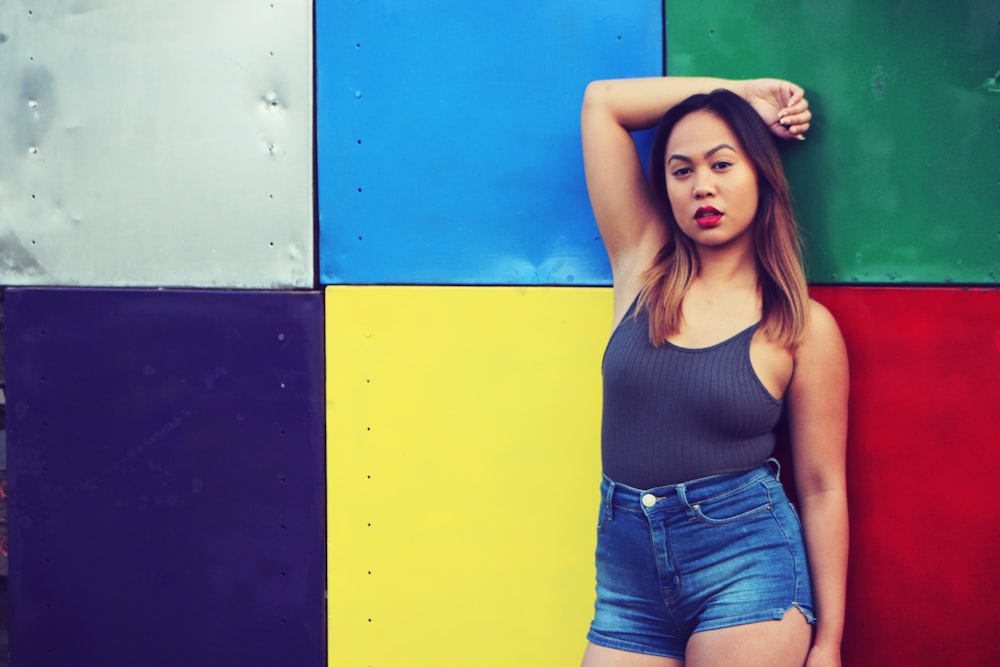 a woman standing in front of a colorful wall