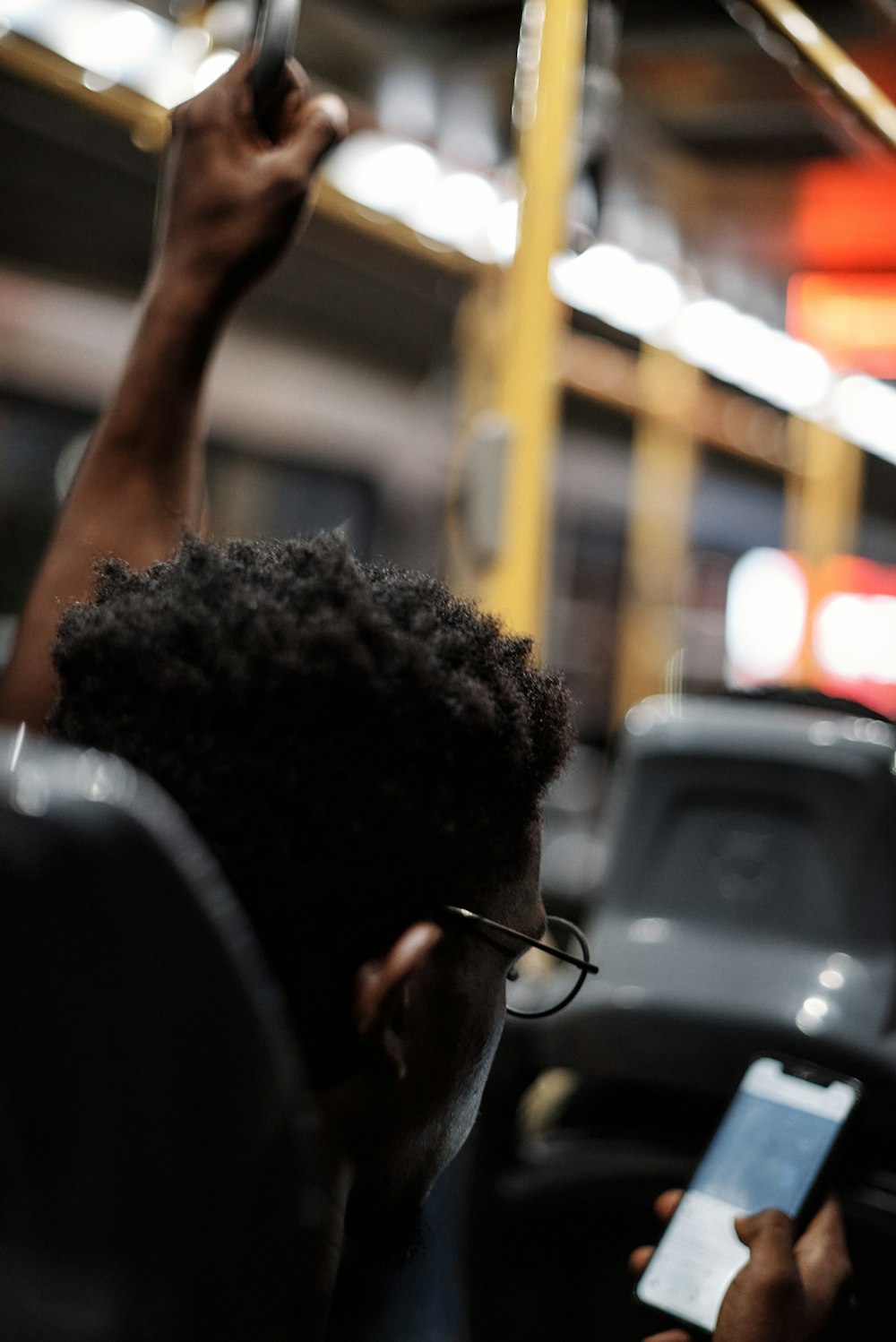 a person on a subway using a cell phone