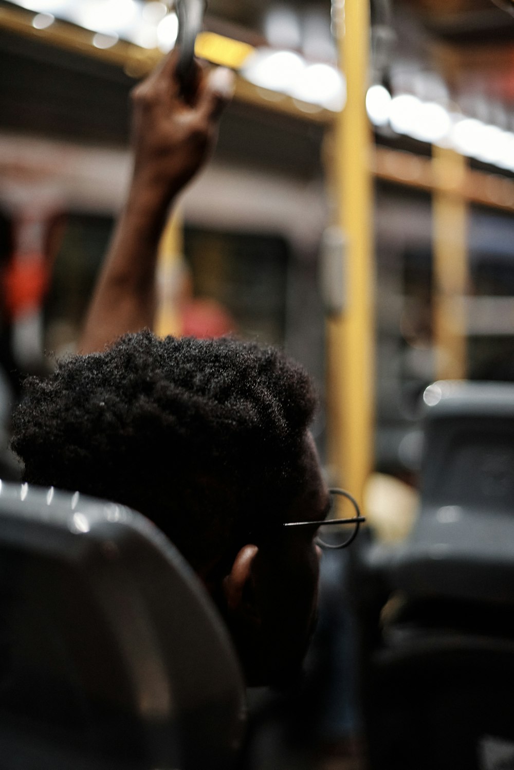 a woman on a train holding a cell phone