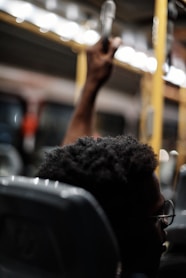 a man sitting on a train holding a cell phone