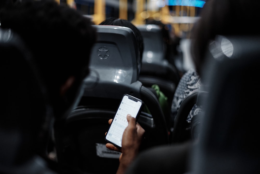 a person holding a cell phone in their hand