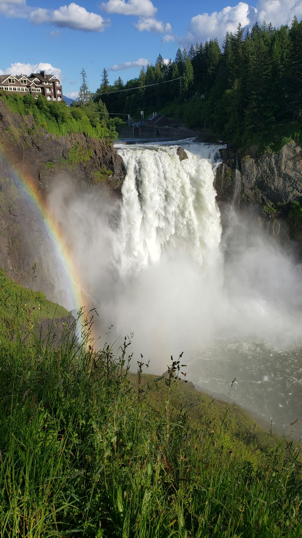 a large waterfall with a rainbow in the middle of it