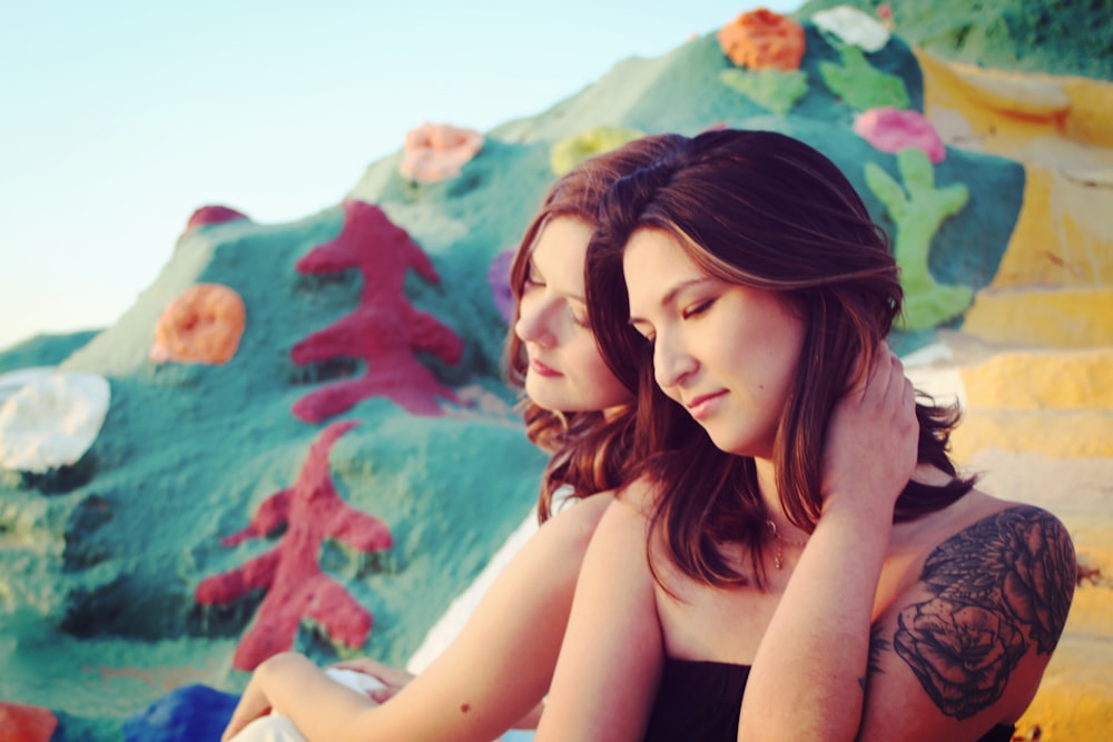 a couple of women sitting next to each other