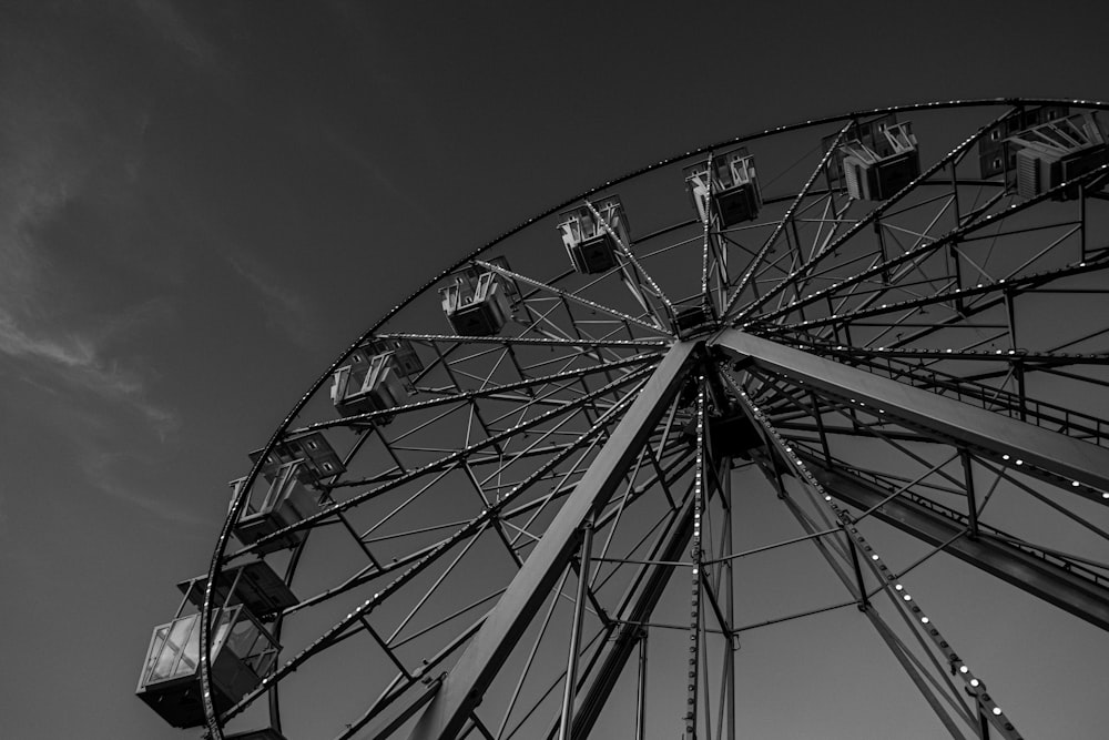 a black and white photo of a ferris wheel