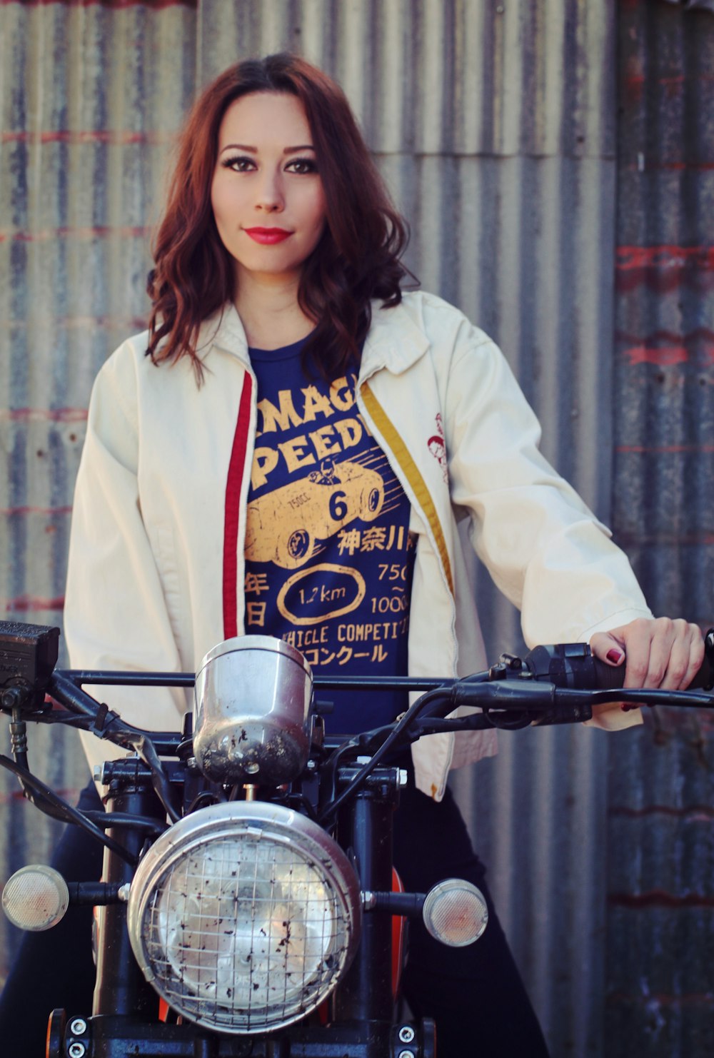 a woman sitting on top of a motorcycle