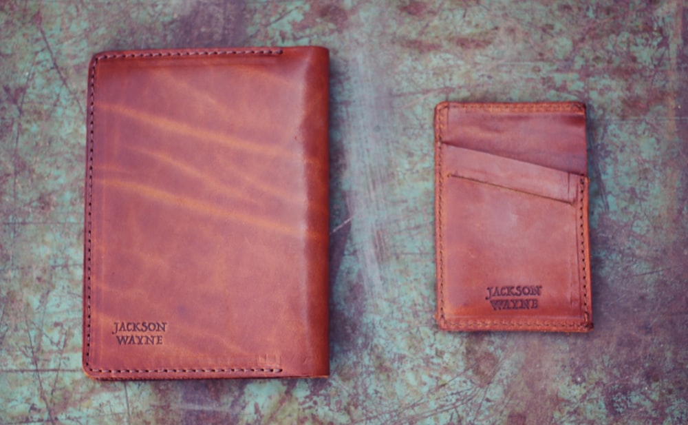 a leather wallet and a leather wallet on a table