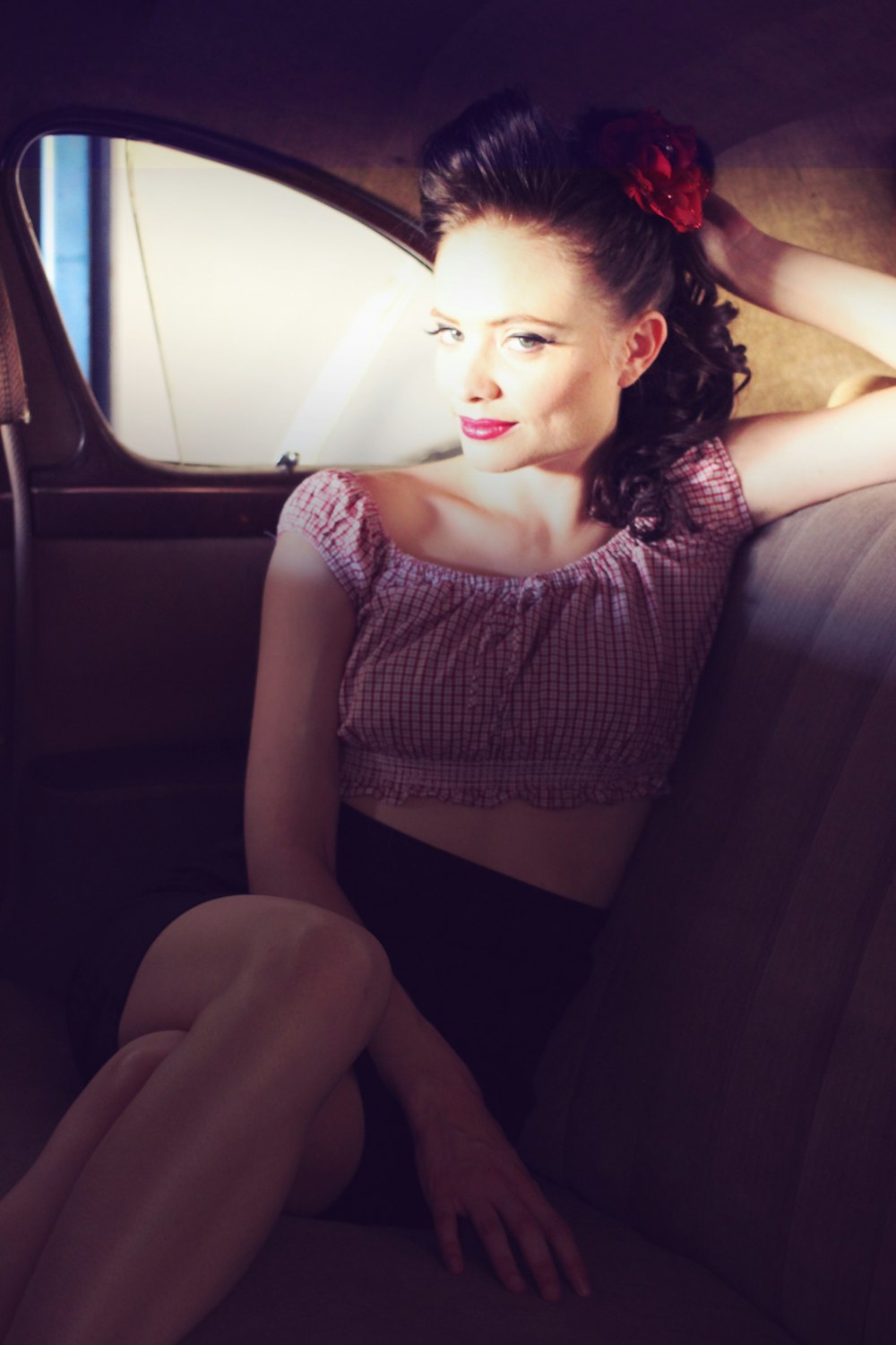 a woman sitting in the back seat of a car