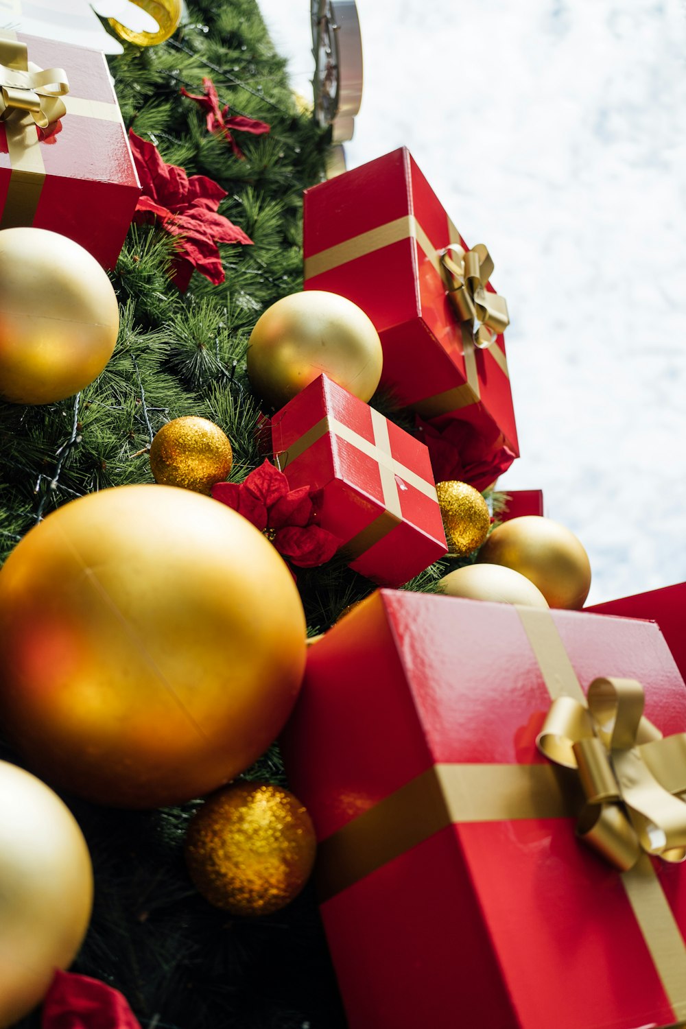 a christmas tree with many red and gold presents