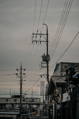 a city street with lots of power lines above it