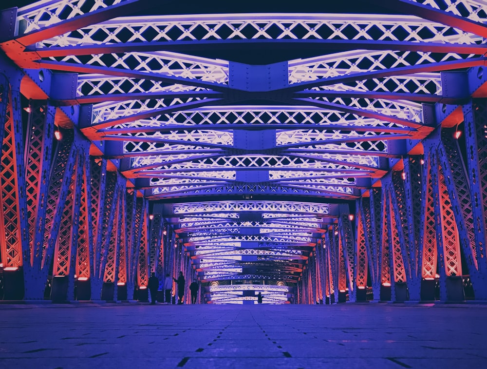 a long walkway with red and blue lights