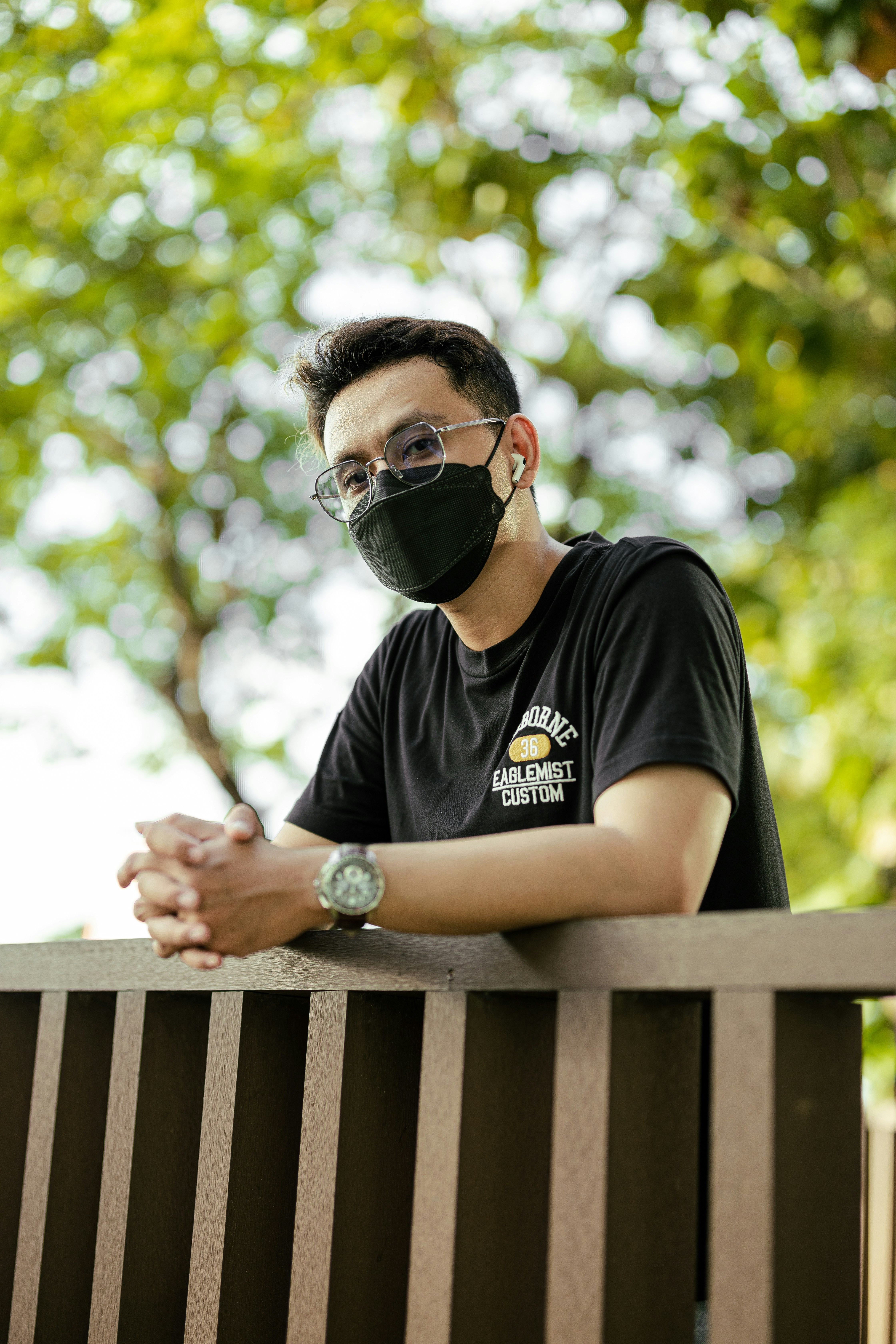 a man wearing a black face mask and glasses