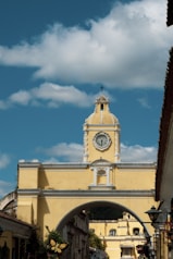 a large yellow building with a clock tower
