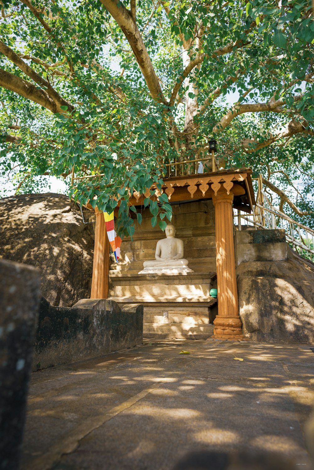 a small shrine under a tree in the shade