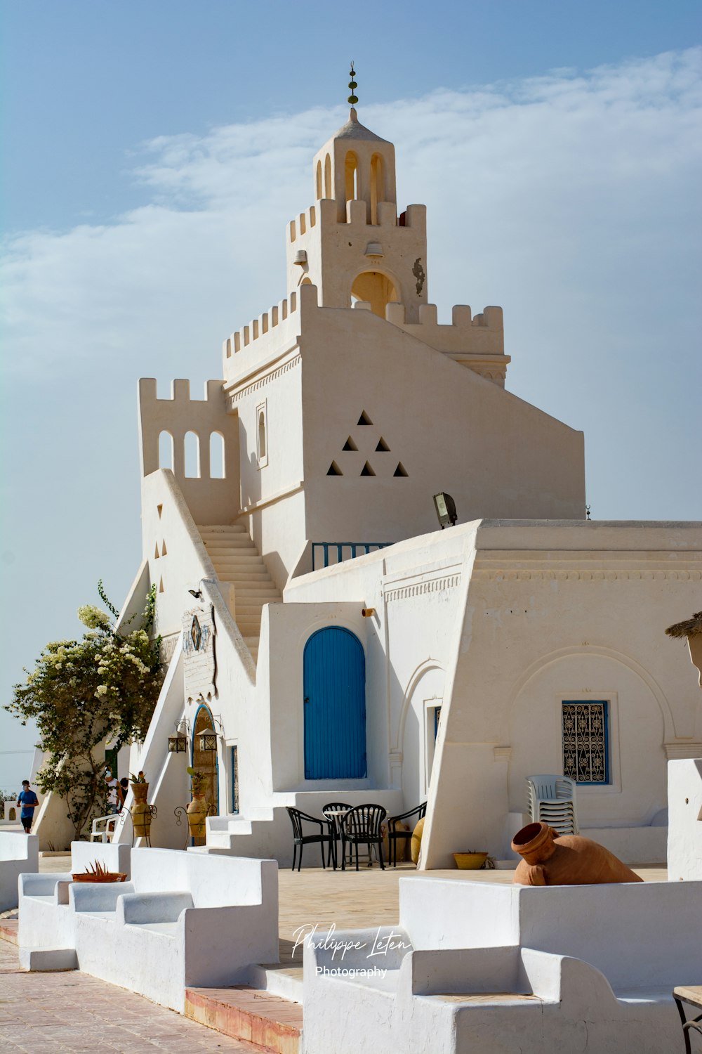 a large white building with a blue door