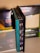 A collection of office supplies neatly arranged, including Avery label and card packages. The items are stored on a shelf and organized upright against a mesh divider. Various colors and sizes of packaging are visible, with text such as 'EcoFriendly' and product numbers.