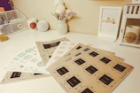 A clean desk with printed designs laid out neatly, showcasing various styles.