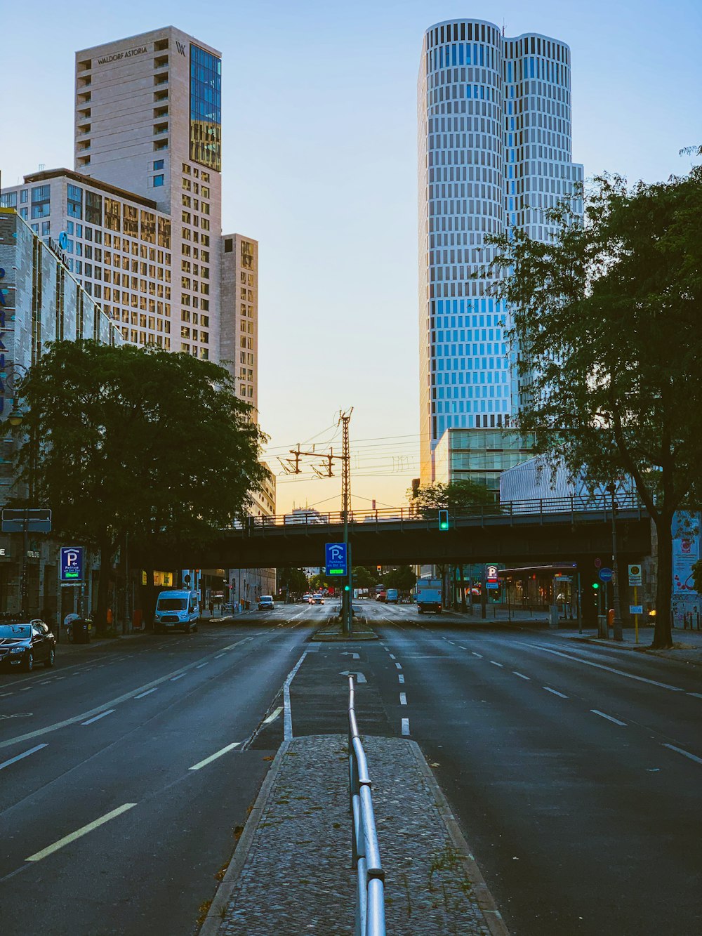 a city street with tall buildings in the background