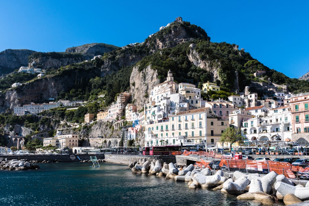 a view of a town on a cliff above a body of water