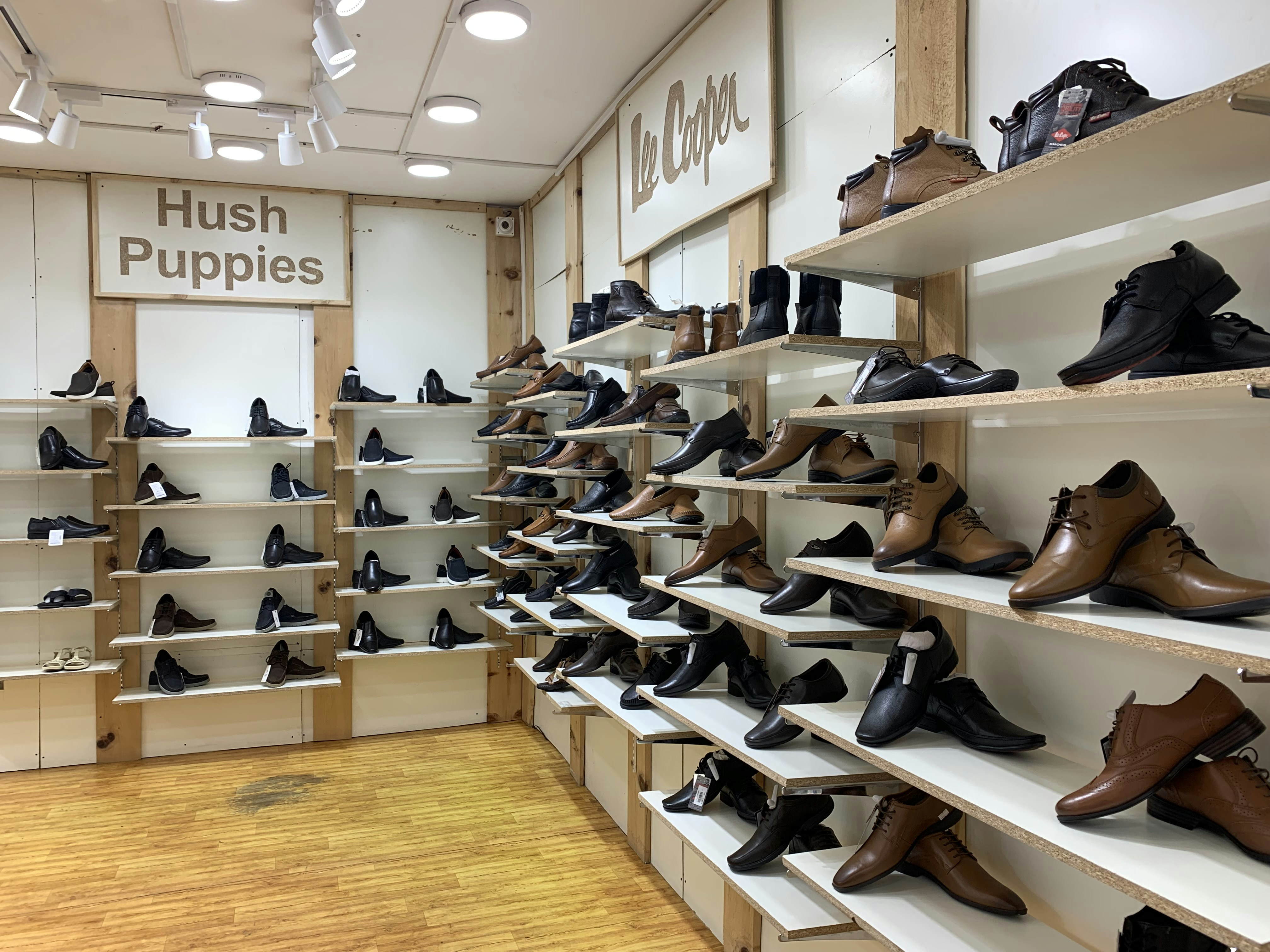 Footwear store showing shoe displays and racks