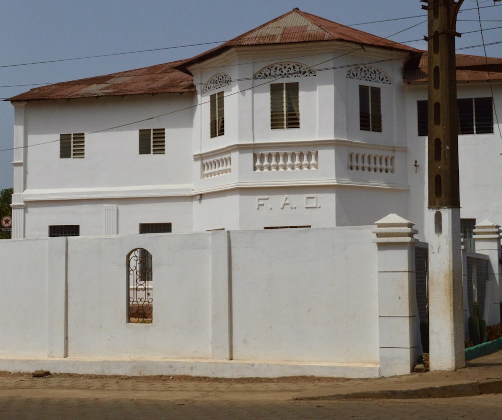 a large white building with a clock on the front of it