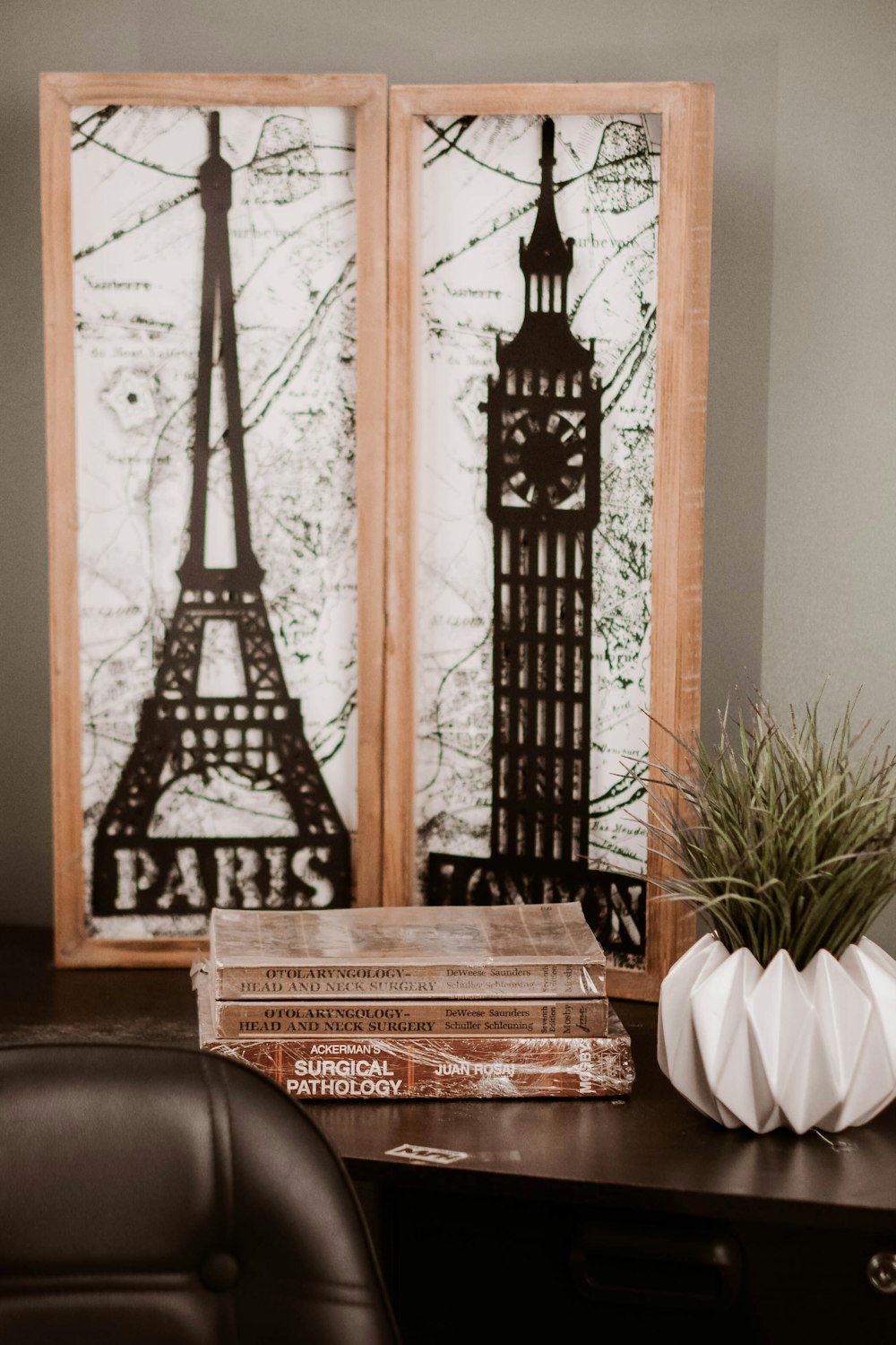 a desk with a chair and a picture of the eiffel tower