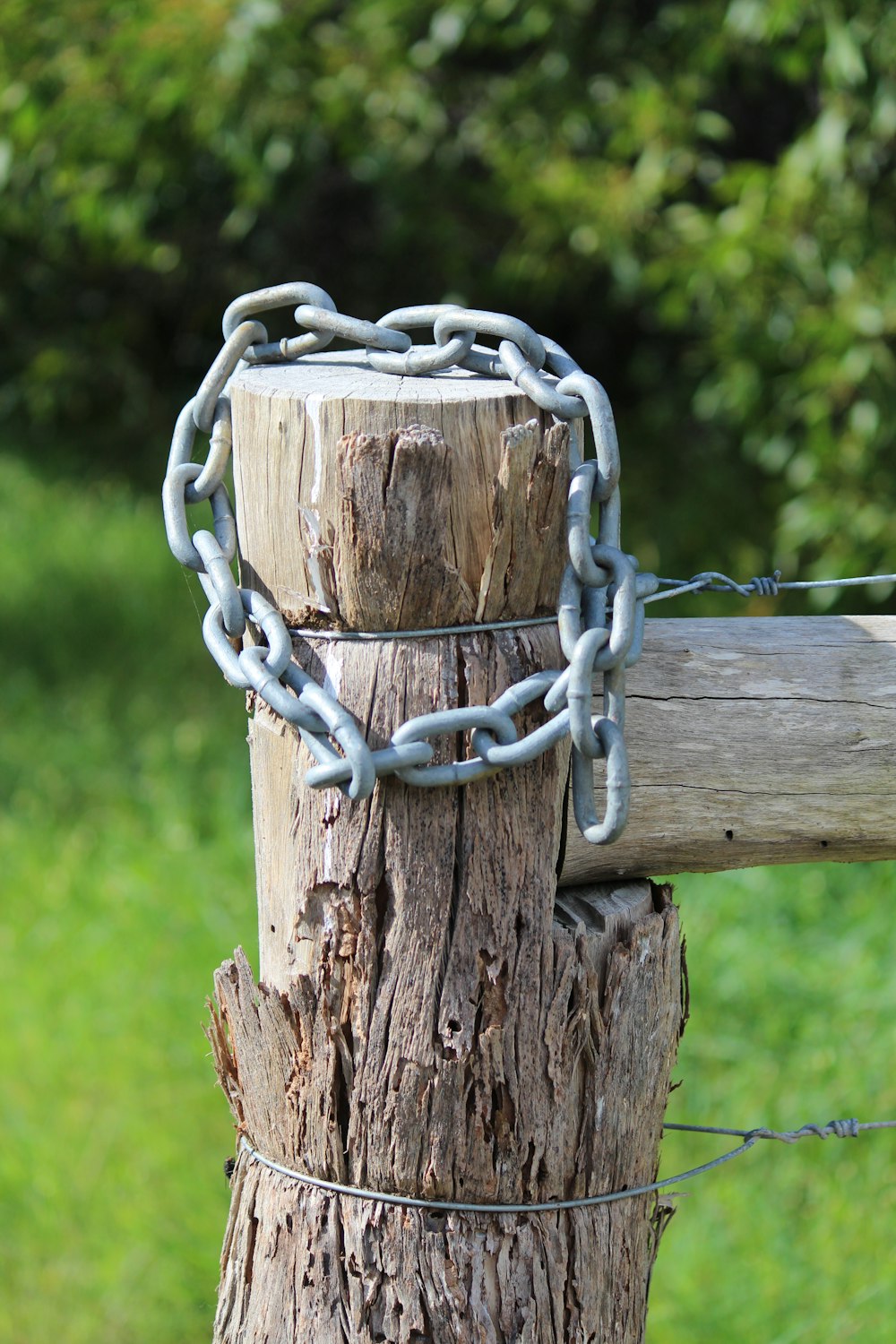 a wooden post with a chain attached to it