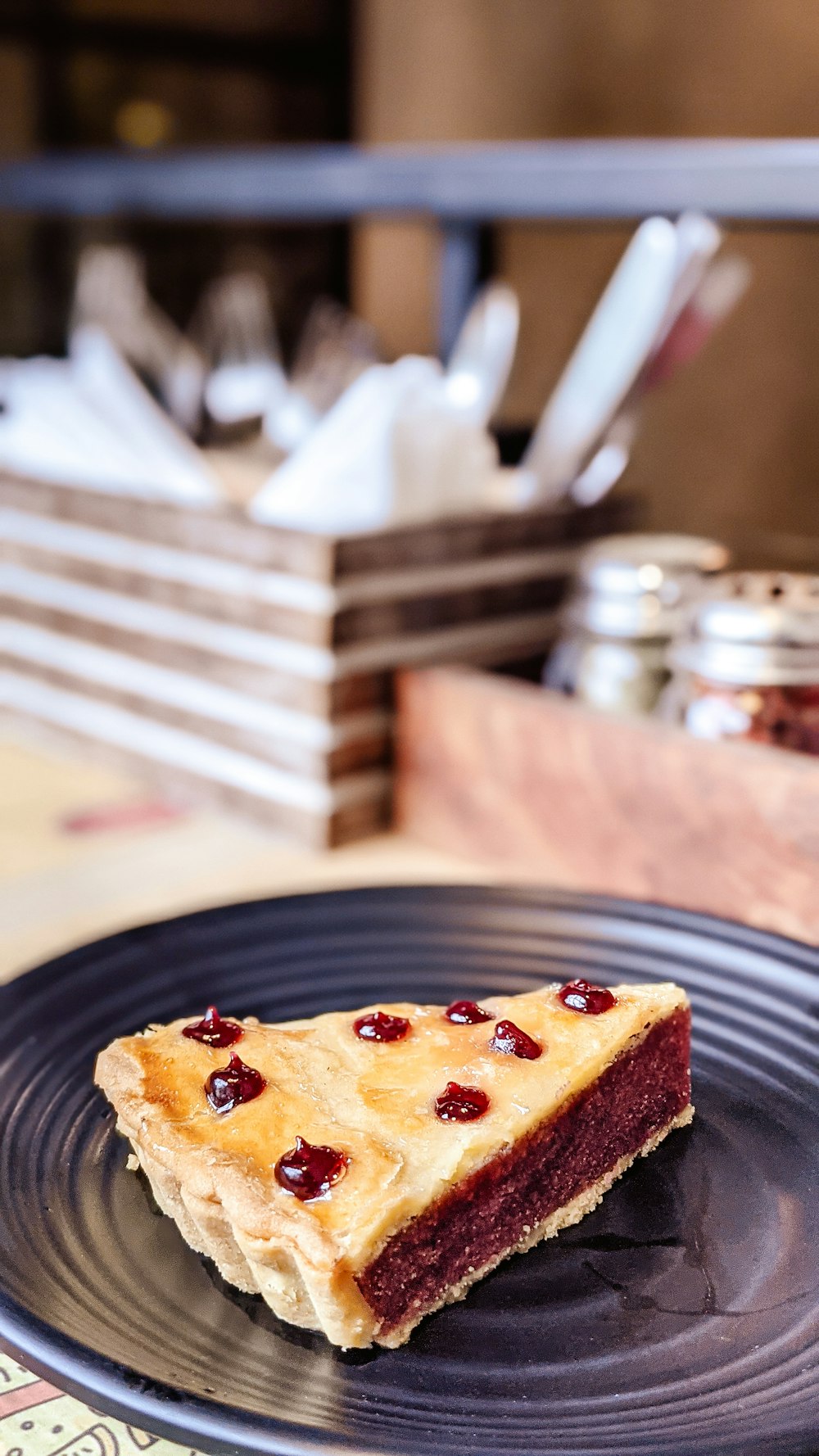 a piece of pie sitting on top of a black plate