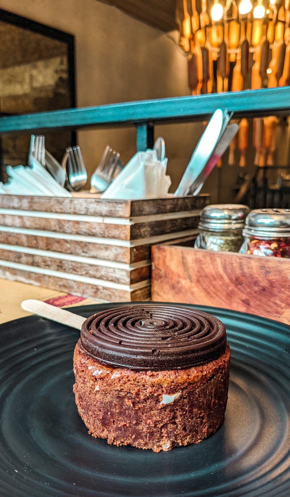 a chocolate cake sitting on top of a black plate