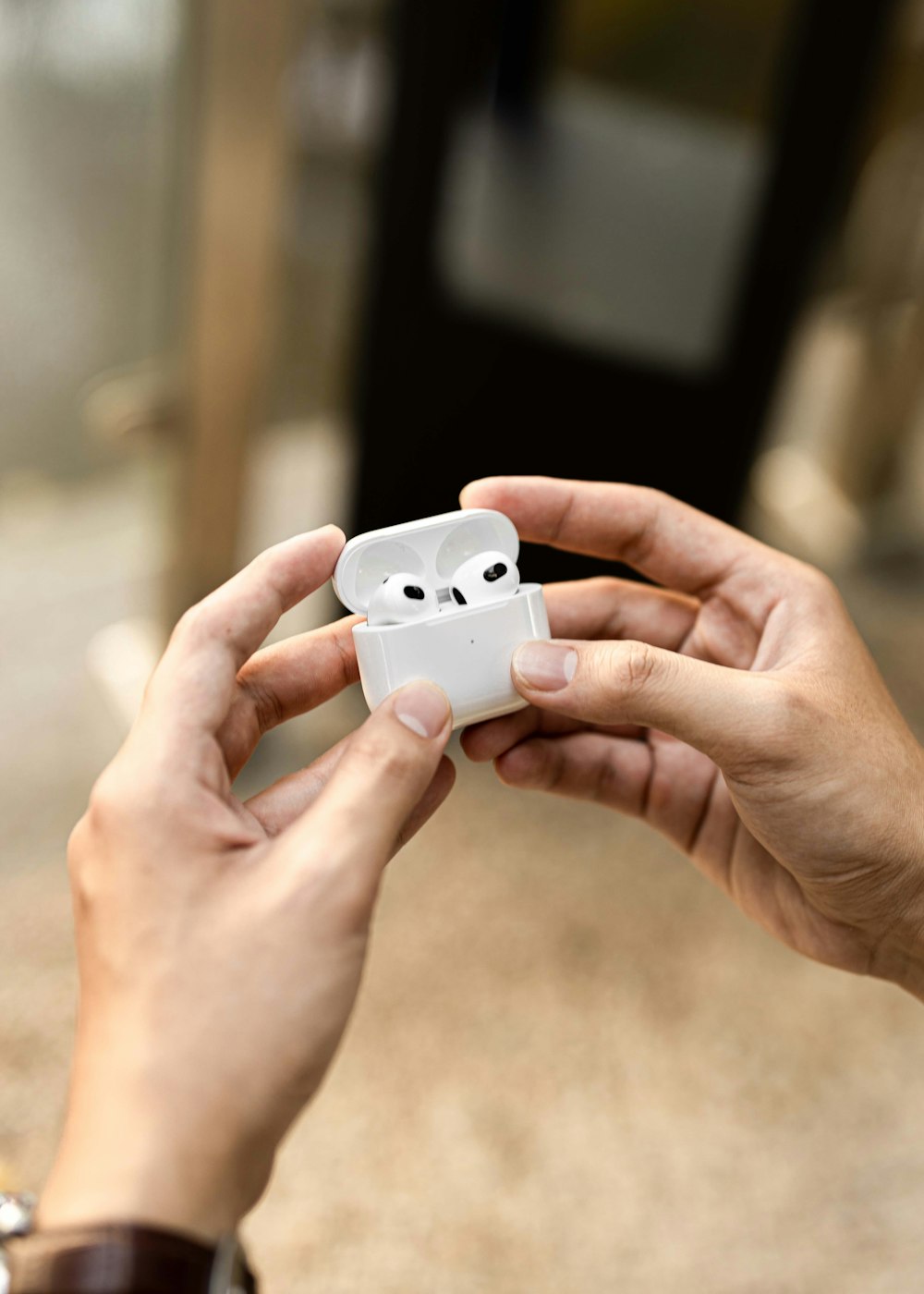 a person holding a small white object in their hands