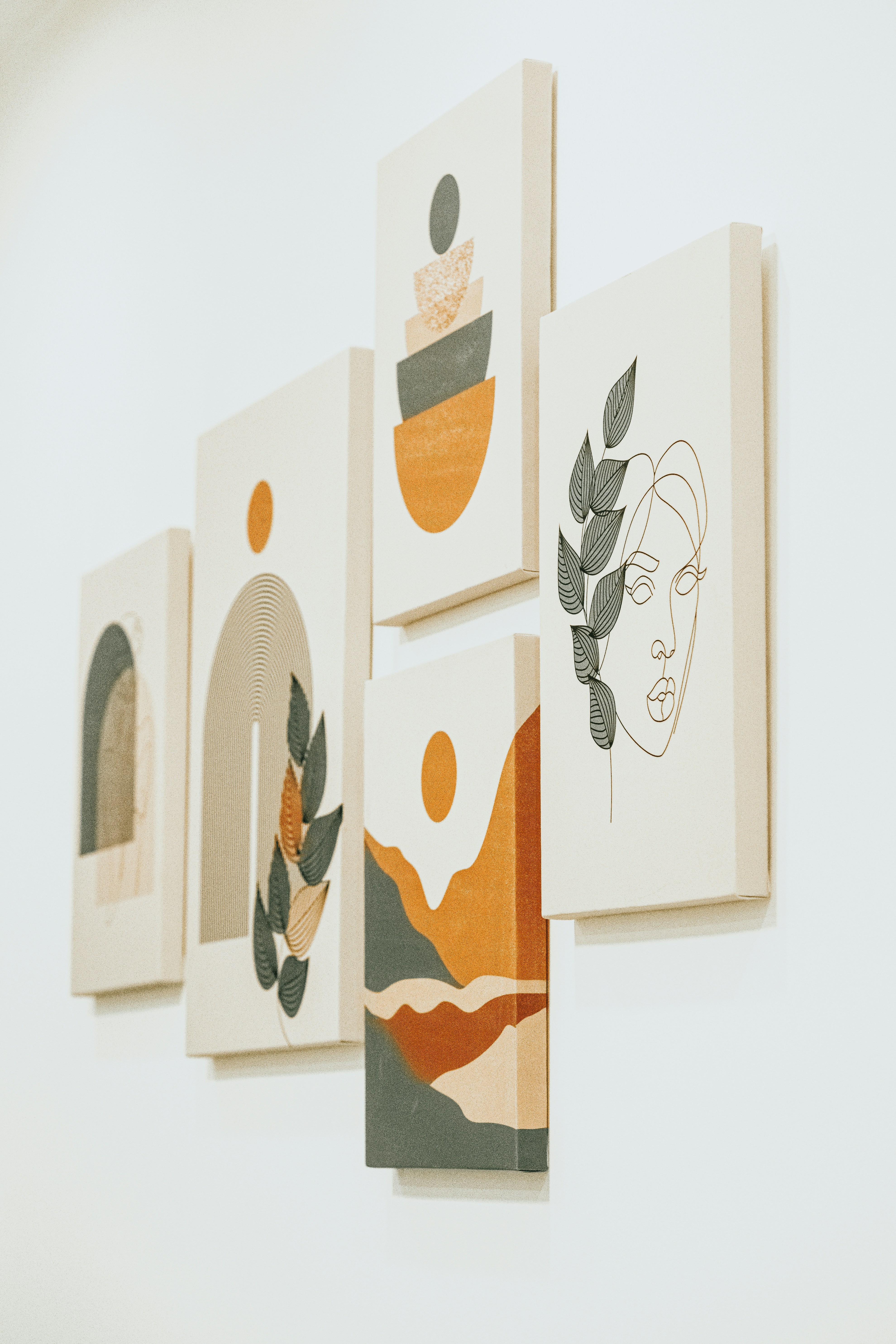 a group of paintings hanging on a wall