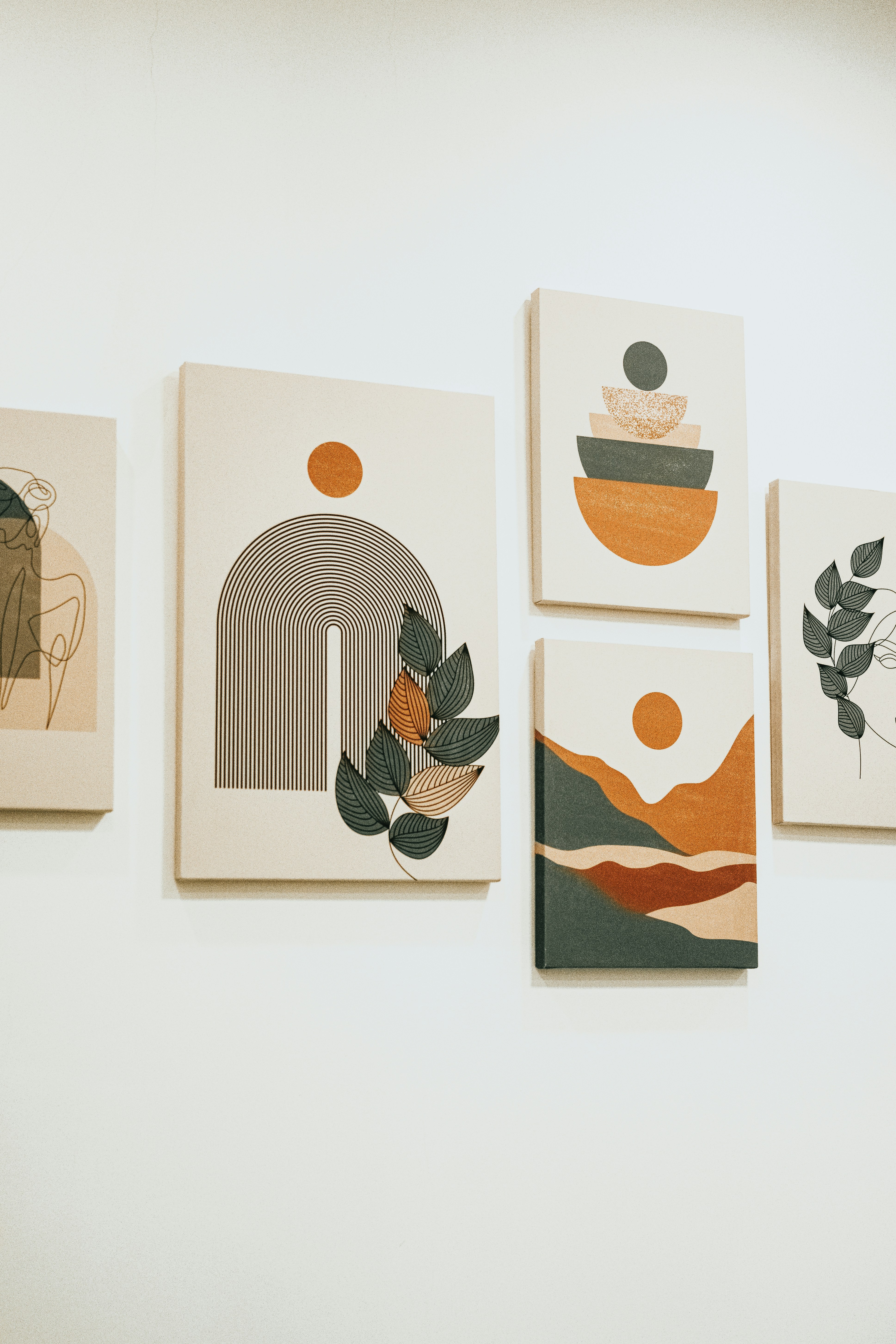 a group of four paintings hanging on a wall