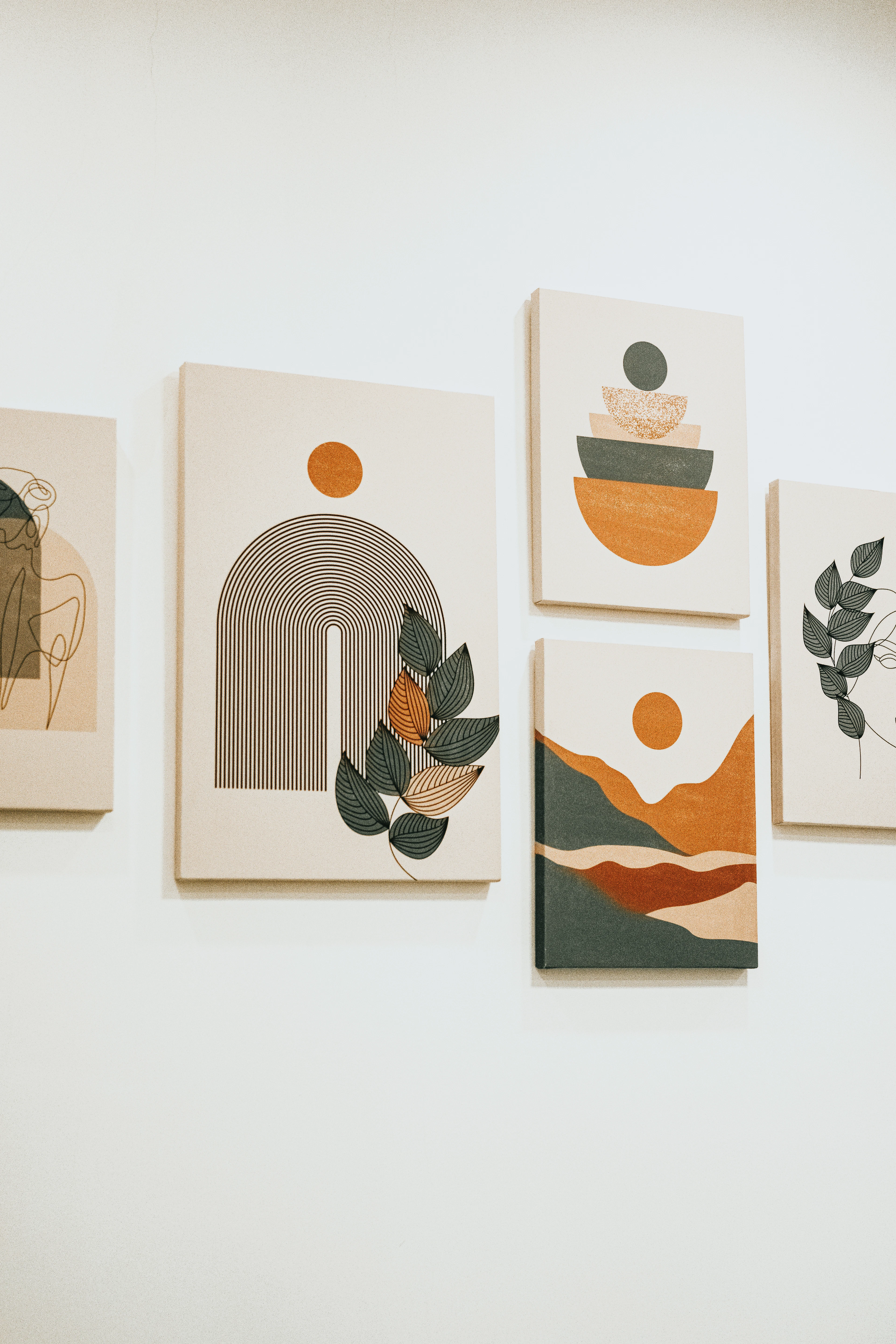 Four paintings hanging on a wall