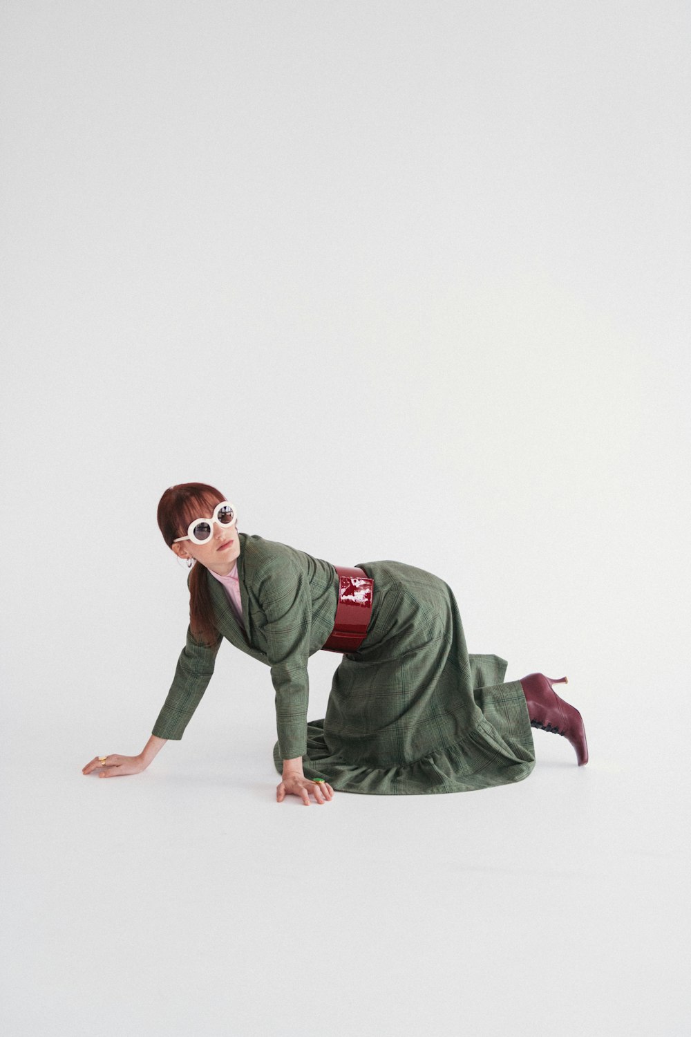 a woman in a green dress is laying on the ground