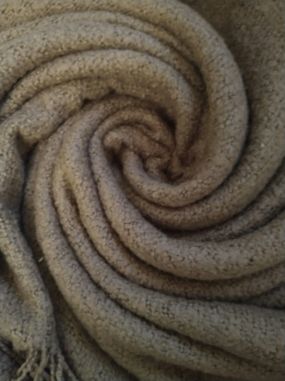 a close up of a blanket with a knot on it