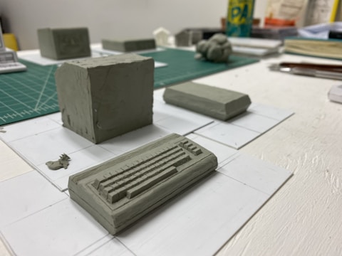 A wide-angle photo of various design prototypes laid out on a worktable.