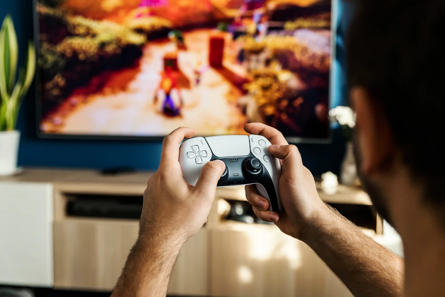Person playing video games using a console controller