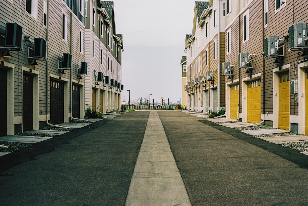 a street lined with row houses with yellow doors