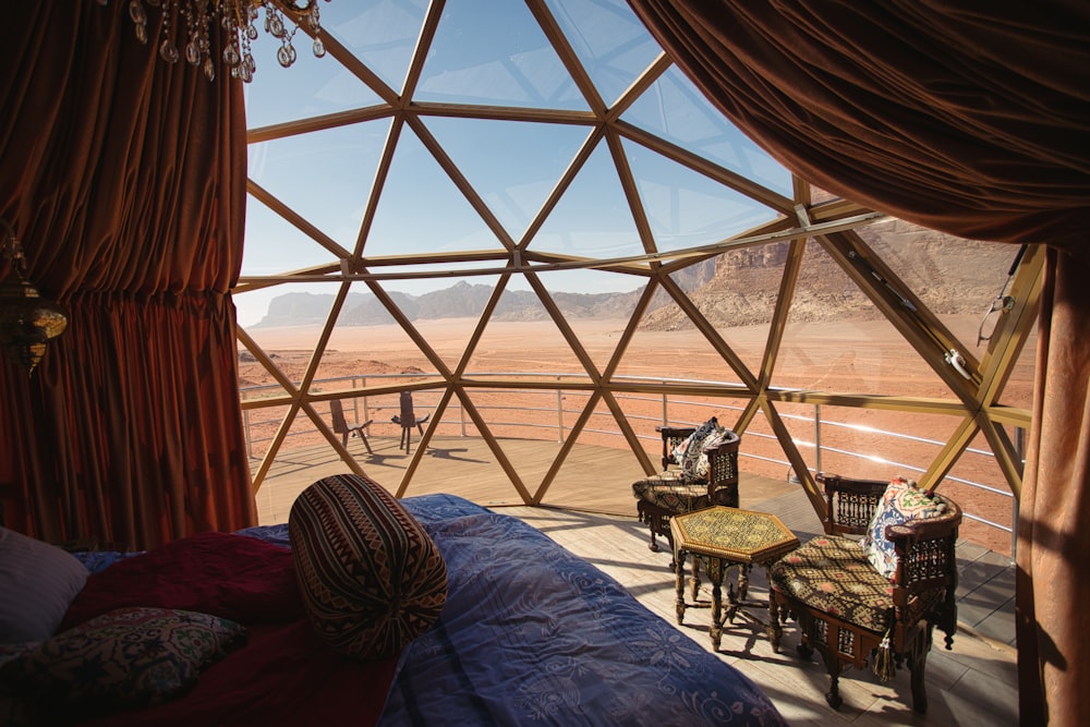 a bed sitting inside of a bedroom next to a window