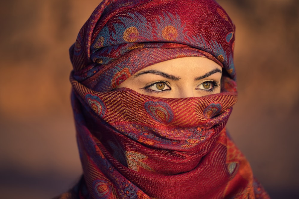 a woman wearing a red headscarf and a red scarf