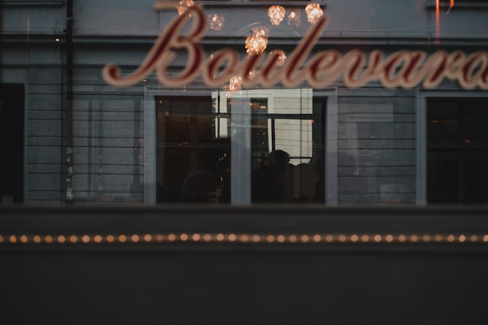 the reflection of a restaurant sign in a window