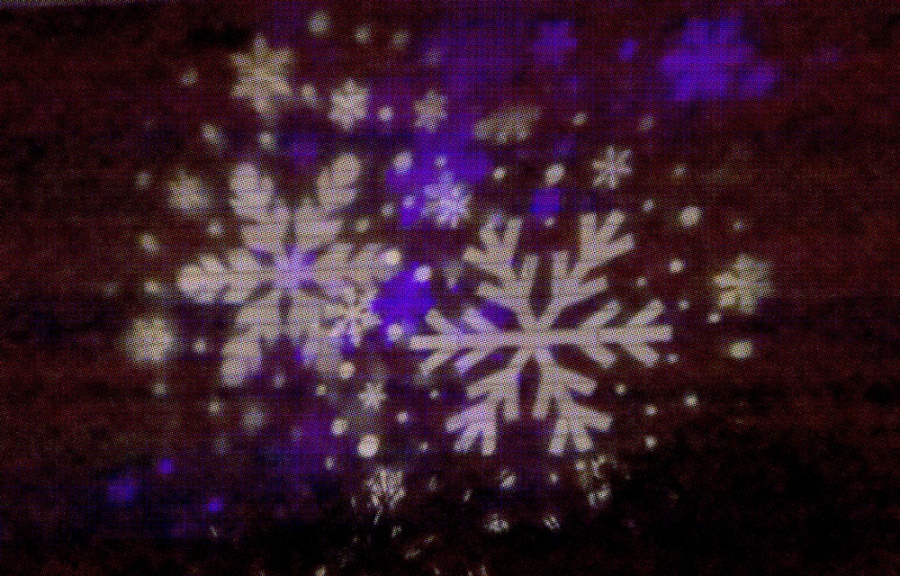 a snowflake is shown on a screen in the dark